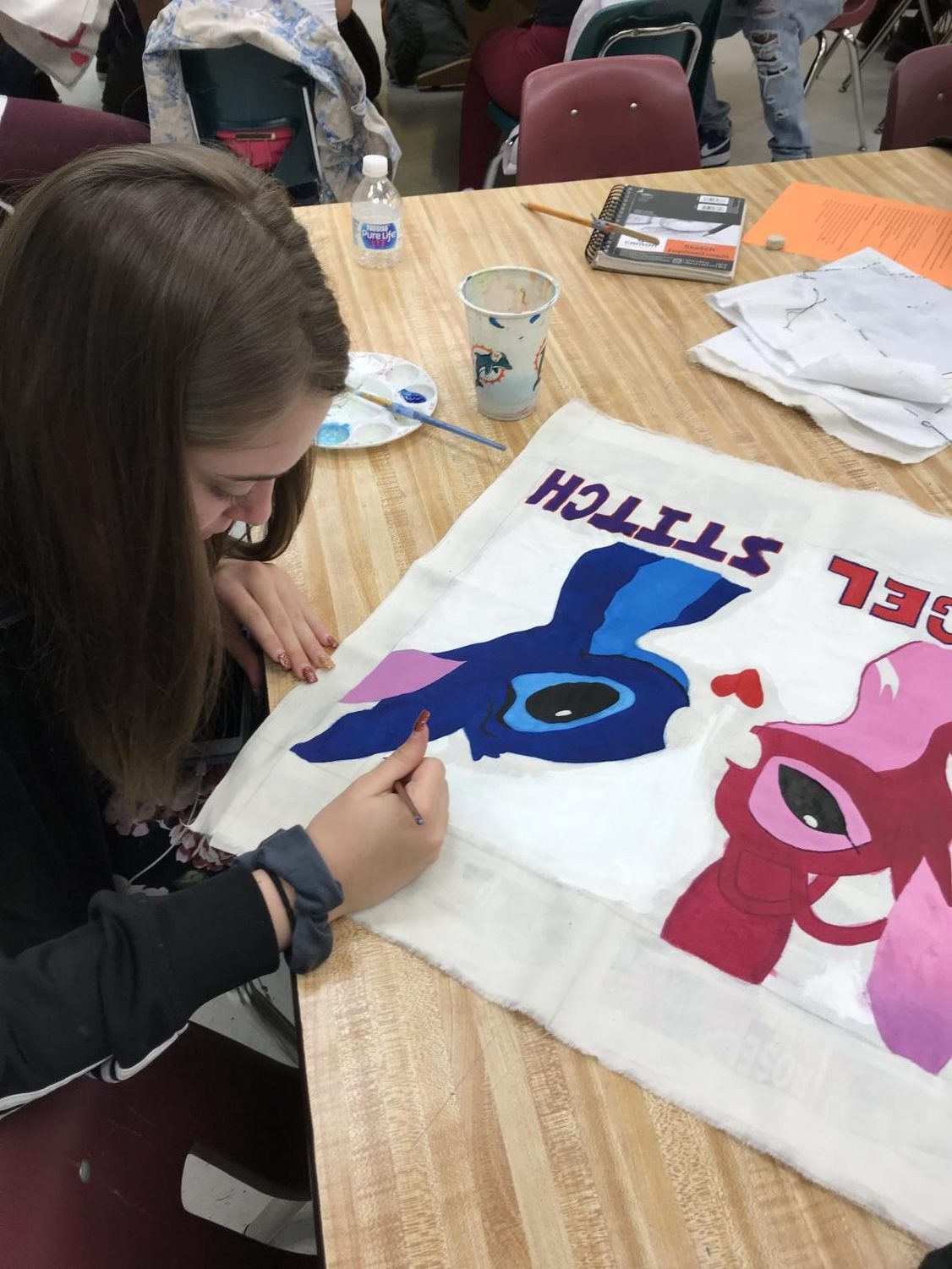 A senior at South Broward works on her final trapunto project on April 13th. Drawing, painting, and stitching together a design of Disney characters. Time and patience is required for detailed projects, such as this one.