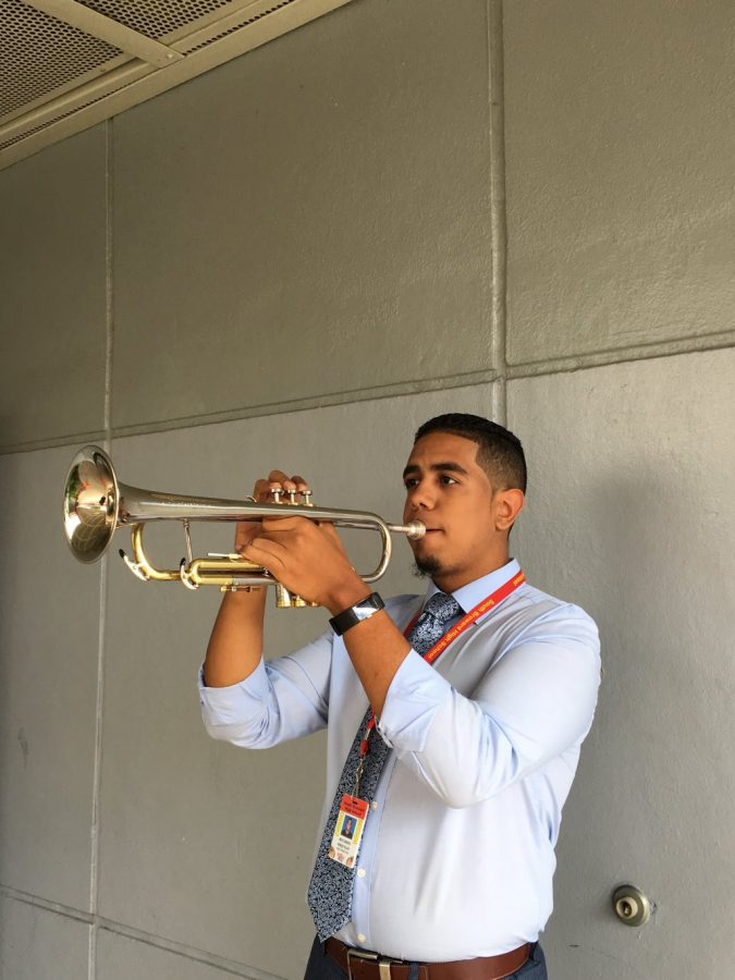 Mr. Esquilin, the assistant band director, practicing his work on the trumpet. 
