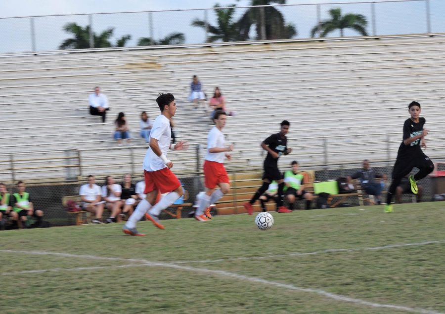 Damian Fernandez dribbles against the Archbishop defense in the final minutes of the first half. (4-1 Win against Archbishop McCarthy)
