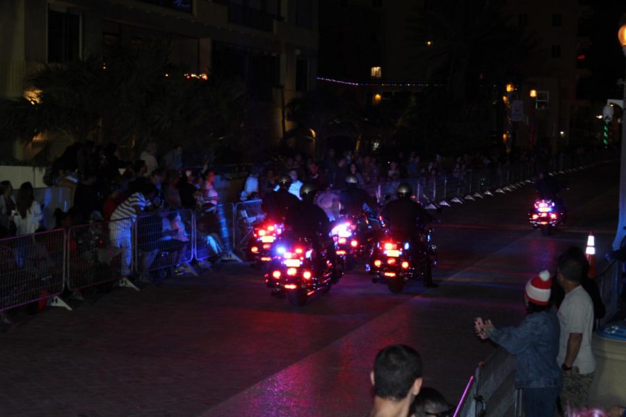 Police squads drive along the boardwalk during the parade. Police officers were scattered throughout the parade in order to keep the peace; police officers were placed among the audience.