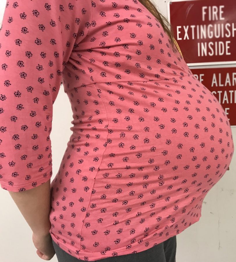 Science teacher, Ms.Fallmann, poses happily for a picture two weeks before her due date. 