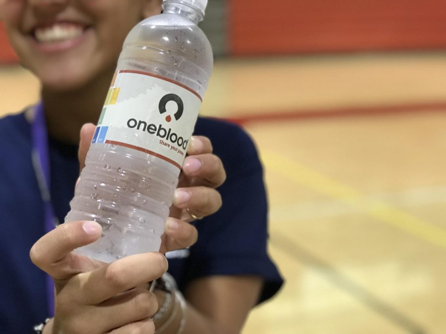 Daniela Garcia of the HOSA Club quenching her thirst after hard work volunteering for the blood drive.