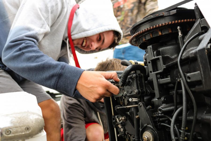 Terence Addrison works on fixing a problem with a motor.