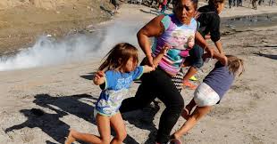 A mother and her children flee after U.S. Border officials fired tear gas on migrants gathered at the San Ysidro border.