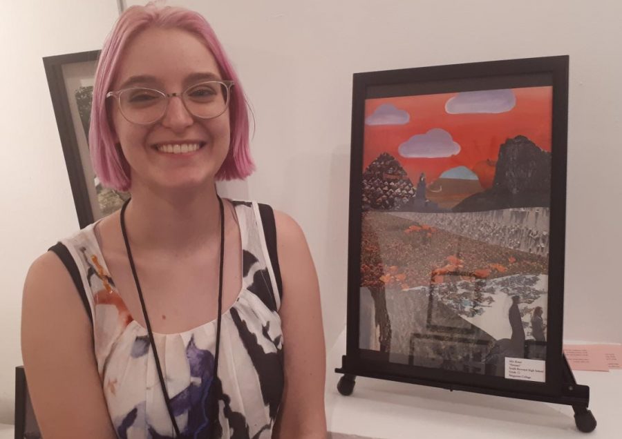 Mia Bonet, senior, stands next to her piece entitled Houses at the Art and Culture Center.