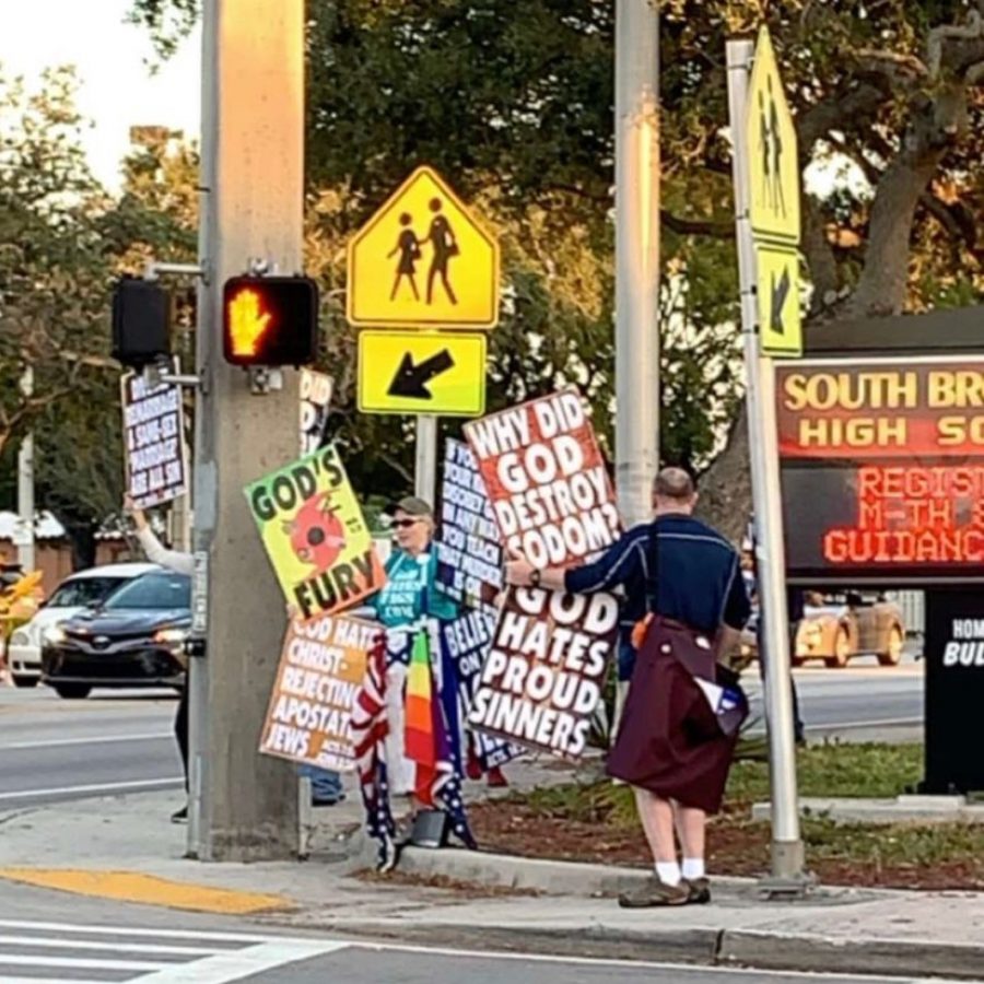 Westboro Baptist Church Protesters wave religious signs