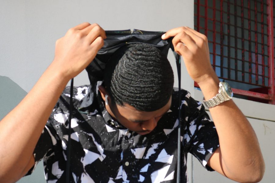 South Broward youtuber Erik Leon removing his durag to show his waves.