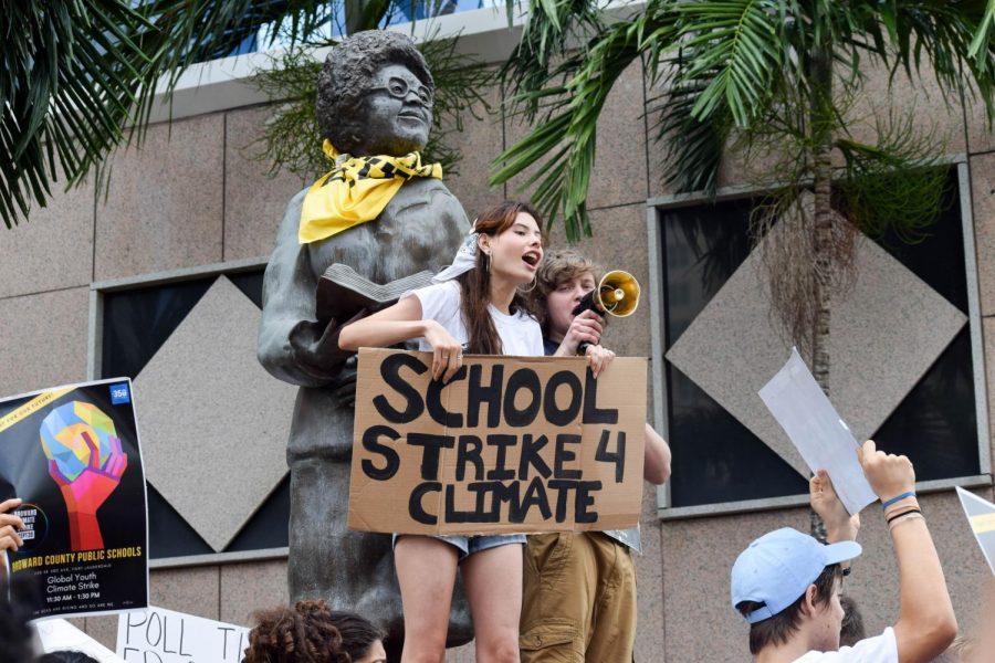 Cypress Bay Student Martina Velasquez stands on the monument in front of the Broward County Public Schools District Office in Fort Lauderdale, FL on September 20, 2019,  with many other students at the protest on climate change. Velasquez is a self proclaimed Political Advocate who actively particitaptes in the Extinction Rebellion Group in her community to fight against climate change.