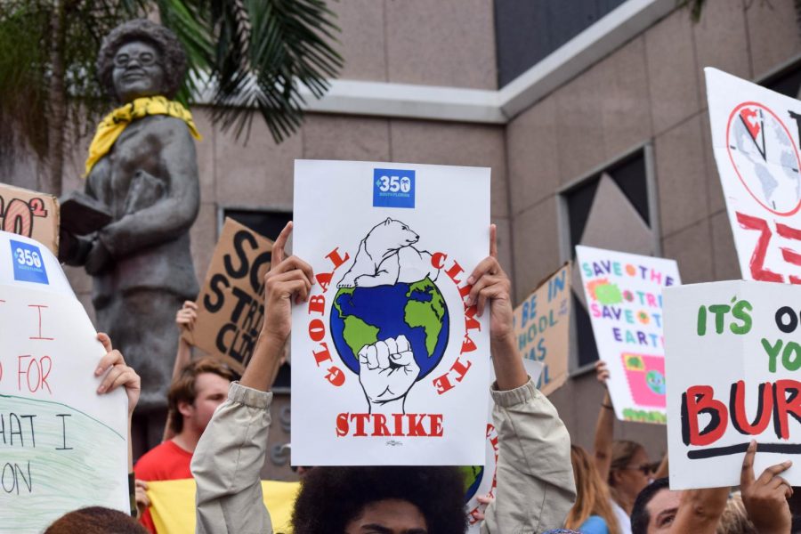 A large crowd of students, teachers, and parents, protest in front of the Broward Public Schools District Office in Fort Lauderdale, on September 20, 2019. The pre-made poster seen here is from the organization 350 South Florida, who sponsored the event. 