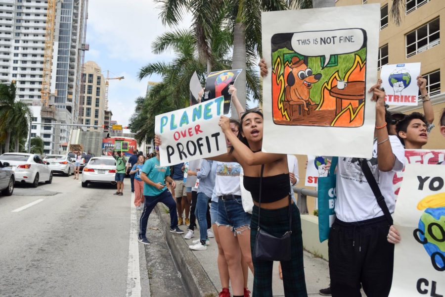 Emily Delacruz, a 12th grade student from South Broward High School protests Climate Change at the Global Youth Climate Strike in Fort Lauderdale, FL on Septemebr 20, 2019. Delacruz is one of many students from South Broward High who missed school to participate in the event, her and many others marched through the busy streets of Downtown Fort Lauderdale shouting at cars and passerby to promote awareness of the issue. 