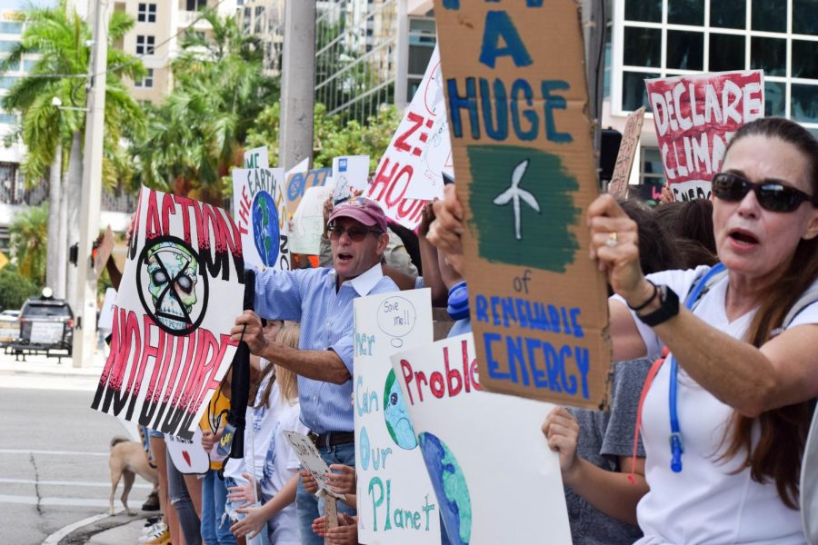 Parents protest alongside their children at the Global Youth Climate Strike in Fort Lauderdale, FL at the Broward County School District Offices, on September 20, 2019. People of all ages attended the strike, some to support their children, and others to simply convey their own thoughts and opinions to the representatives of Broward County.  