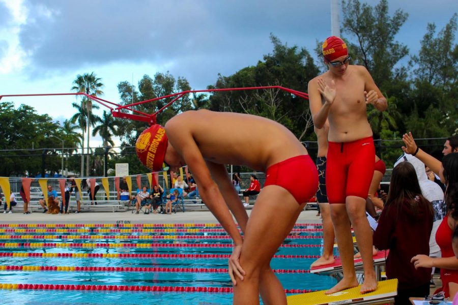 Athlete prepares to dive from platform during 300 yard boys freestyle at South Broward swimming competition on October 10, 2019.