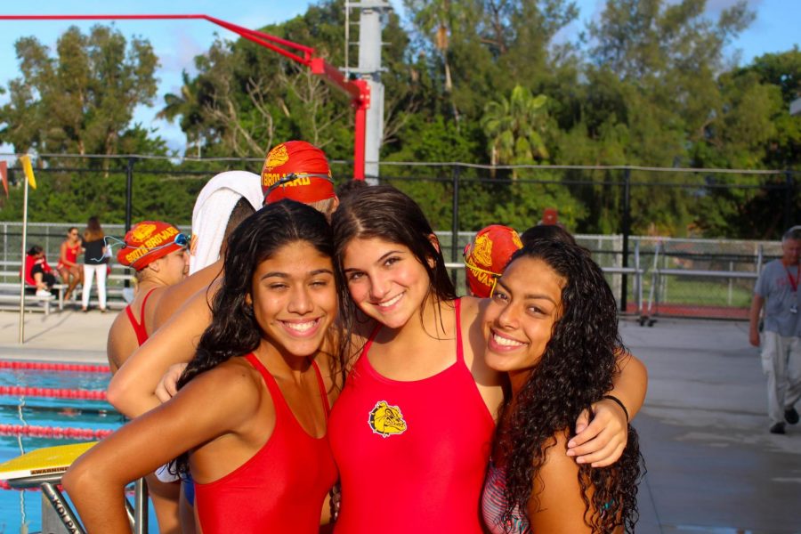 Alexandra Ruiz, Elaine Grossman, and Brianna Hernandez (12th) pose for a picture after their last race at South Broward on October 10, 2019.