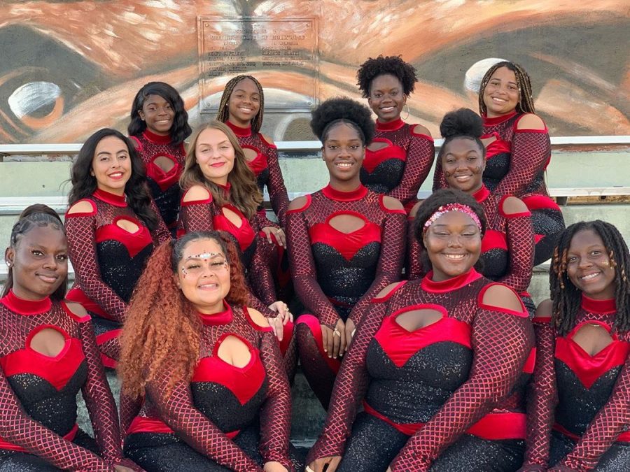 SBHS Color Guard team poses with their black and red sequin costumes. 