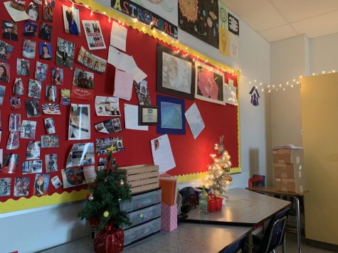 Holiday lights hang all around the classroom. 