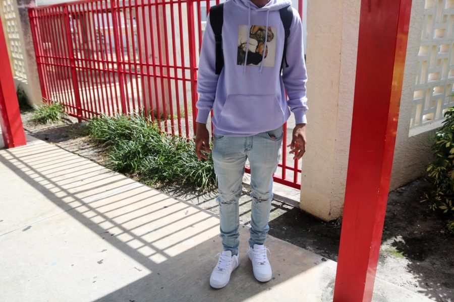 Student styles up his outfit with a classic pair of white shoes and a lavender Ariana Grande Hoodie.