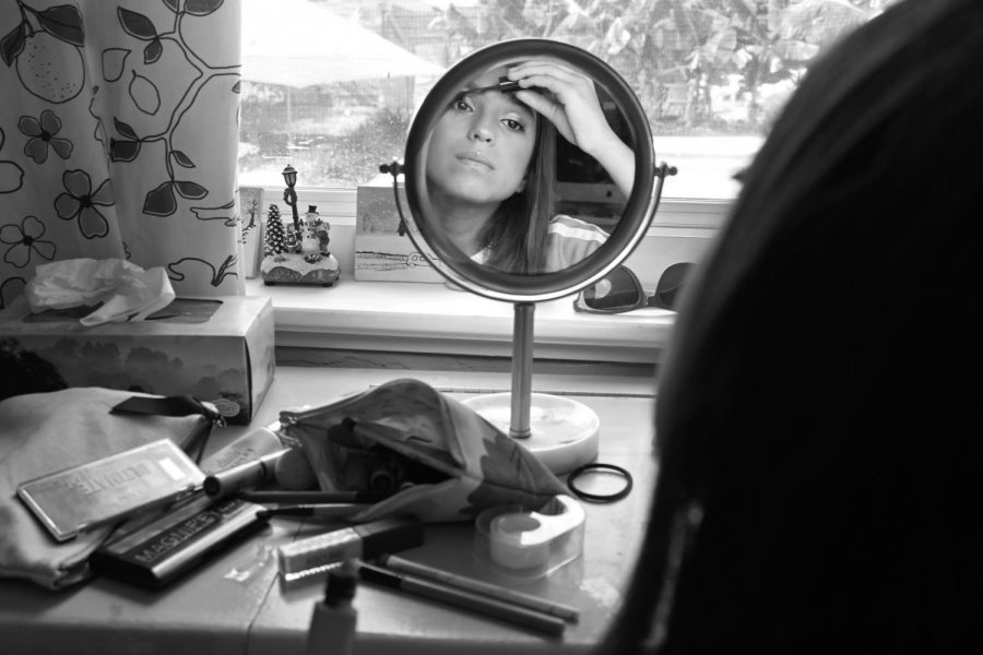 Marlena applies mascara while practicing putting on make-up. I like putting on make-up. Its kinda like art, she said. 