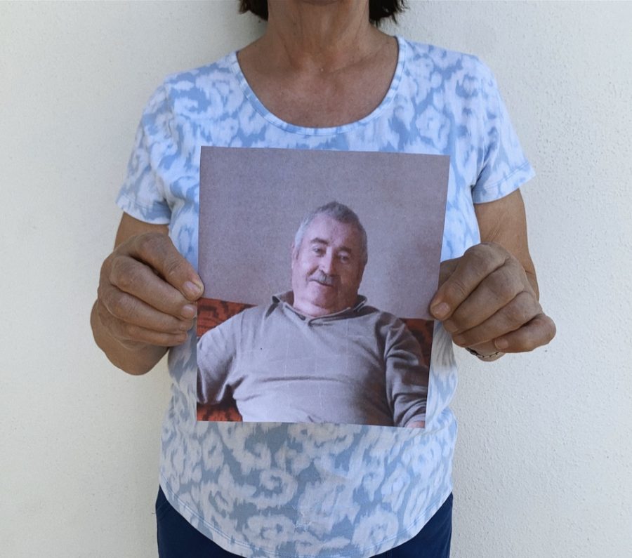 Rafila Bartos holds up picture of husband John Bartos, who is stuck in Romania during the corona virus outbreak.