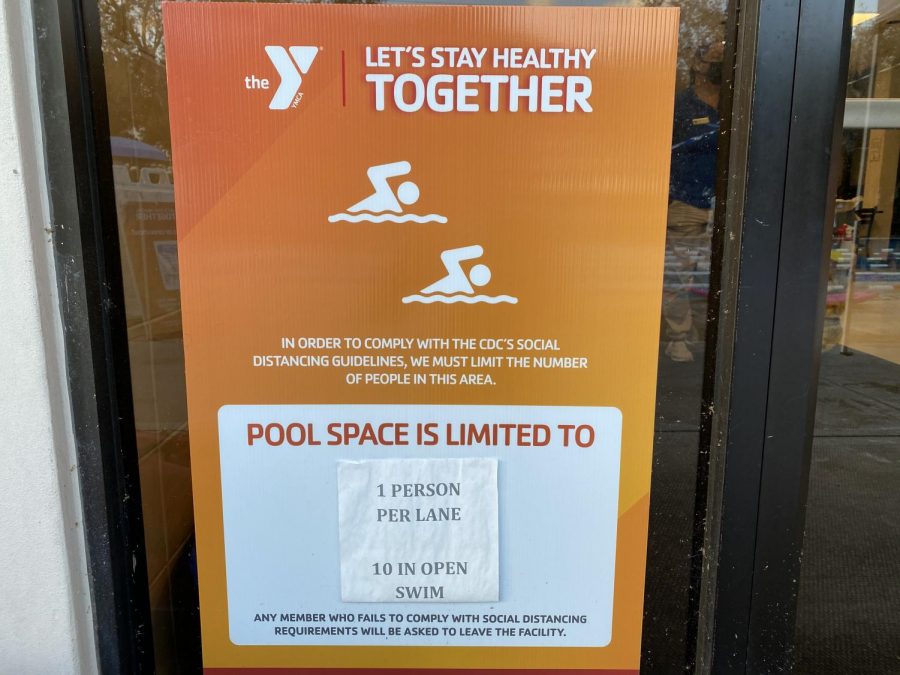 A sign indicates the new pool capacity due to COVID-19.