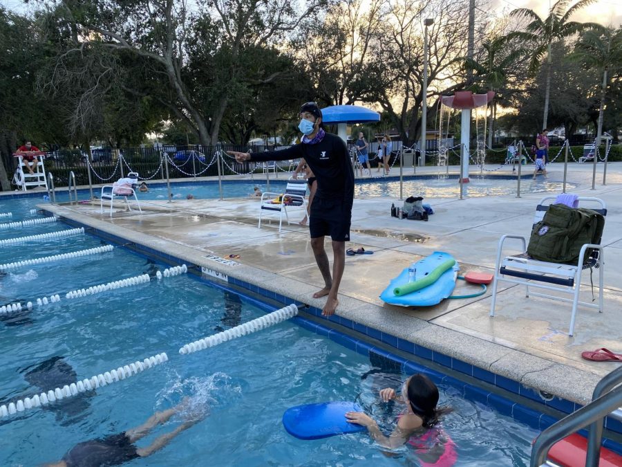 Kenneth Soto, 21, teaches a swim clinic with four students aged 8-13. Soto keeps his mask on while teaching outside of the water to prevent the spread of COVID-19.