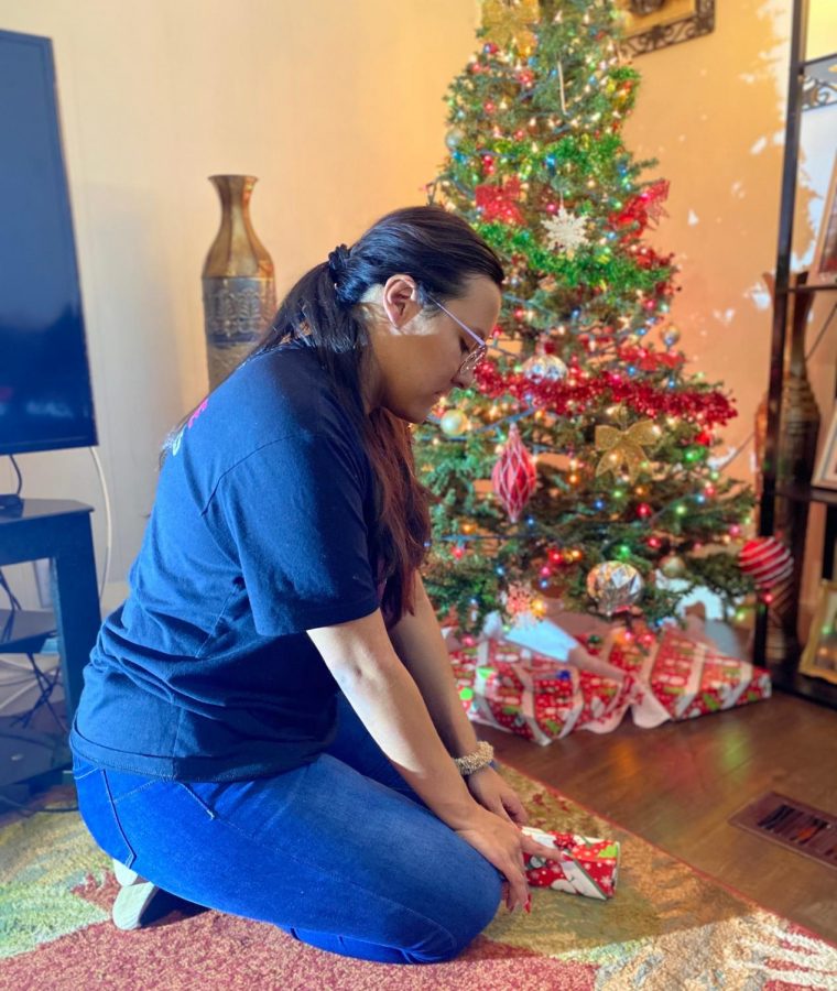 21 years old, Michelle Flores is wrapping Christmas gifts for her family.