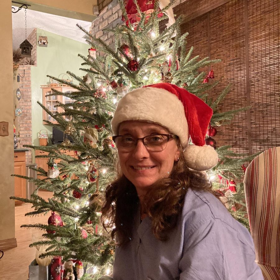 Dianna Colabella sits in front of her newly decorated Christmas tree.