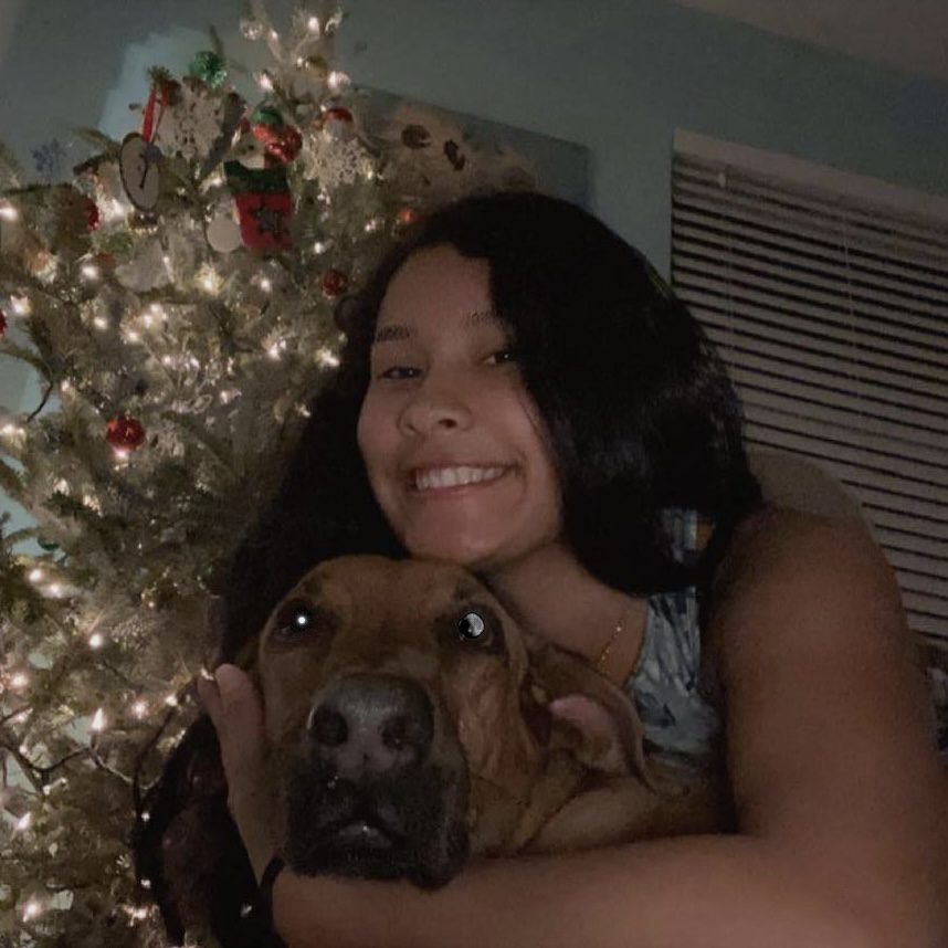 Fabiana celebrating Holidays with her dog.