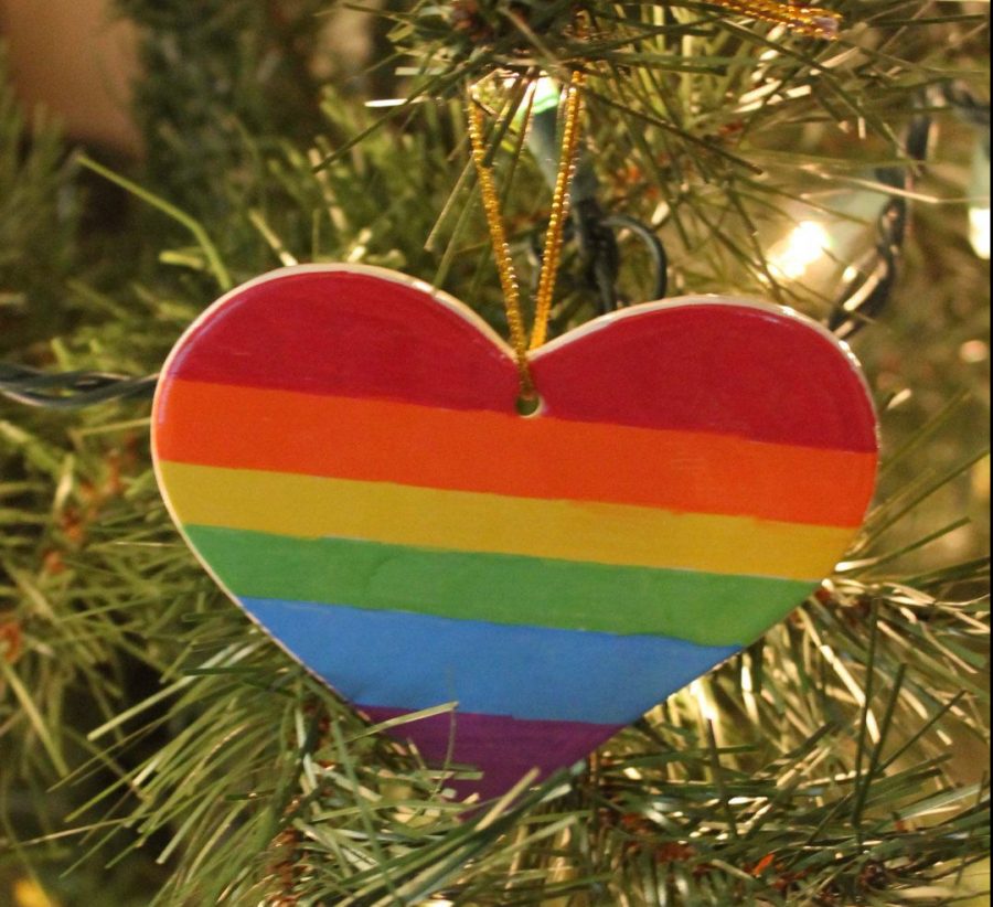 LGBTQ+ flag ornament sits on a Christmas tree to highlight pride among the holidays. 