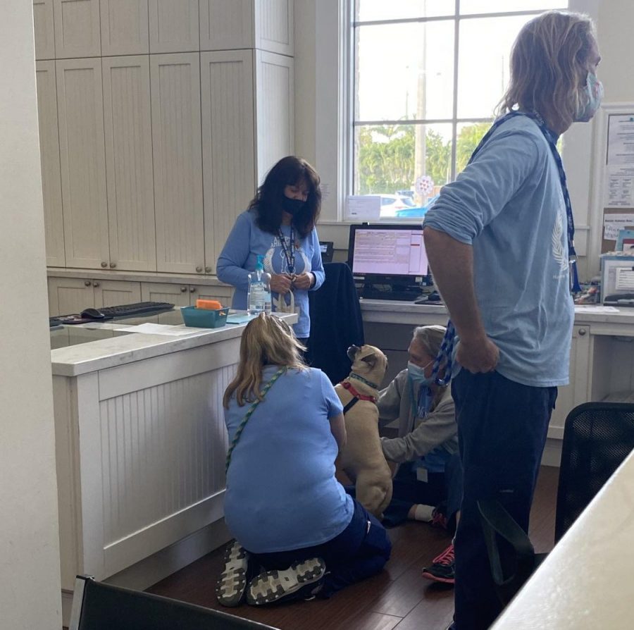 The family waits patiently as the employees prepare their furry friend for his new home. They go through the regular procedure of adopting. They bathe him, while going over its vaccinations and chip information. They are very gentle and have a lot of love for their dogs and are excited for them to have a new home.

