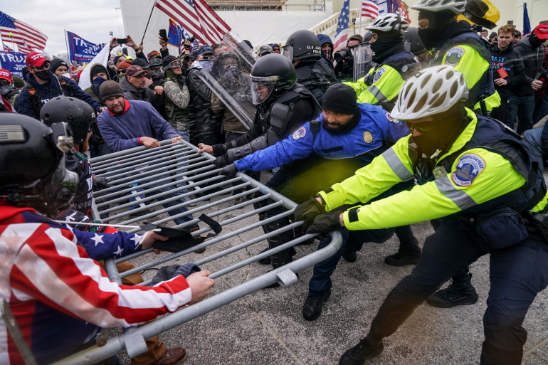 Trump supporters try to break through a police barrier, Wednesday, Jan. 6, 2021, at the Capitol in Washington. As Congress prepares to affirm President-elect Joe Bidens victory, thousands of people have gathered to show their support for President Donald Trump and his claims of election fraud.(AP Photo/John Minchillo)