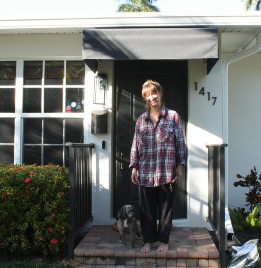 Felipe and his owner, Laura, stand outside their house. Felipe ran away back in December when a house guest left the back door open.