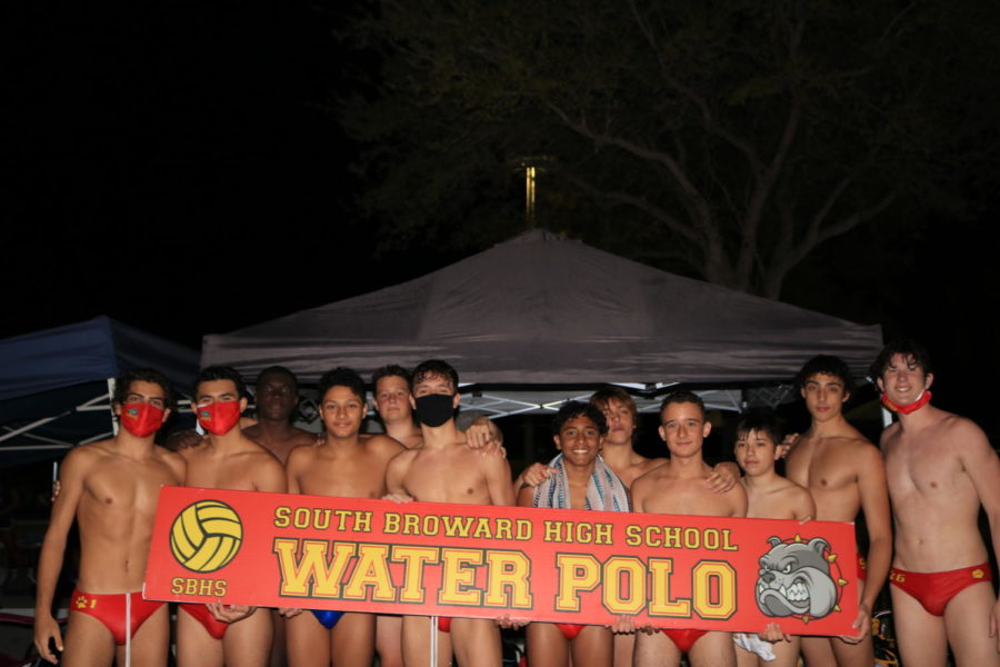 The+boys+team+gathers+for+a+group+photo+while+holding+up+the+SBHS+Water+Polo+sign.+The+boys+came+up+short+in+the+Forza+Stefano+Tournament+and+placed+9th+overall.