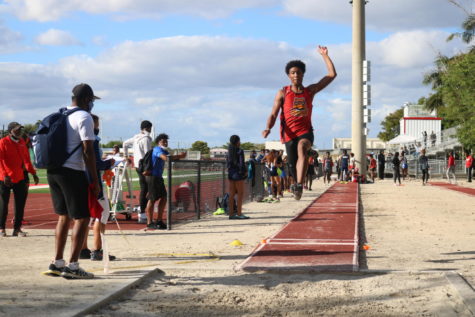 SBHS Senior Cameron Jones takes a leaping dive into the long jump pit during the track meet at Carndinal Gibbons on March 9th. Jones took first place in the long jump out of 23 jumpers after jumping 25.3 meters. 