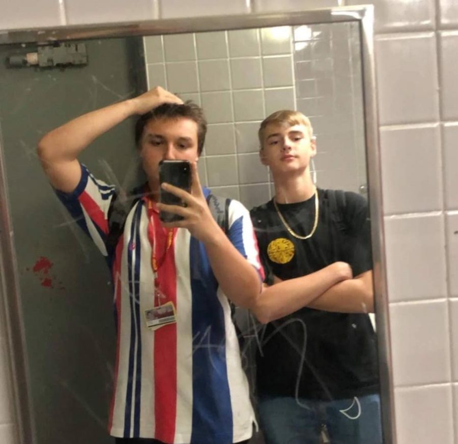 Lucas Parron uses a bathroom mirror to snap a photo of himself with Shane McVey during a break between classes. 