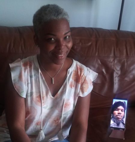 Simone Knight sits next to a picture of her son, Cory Pannell. 