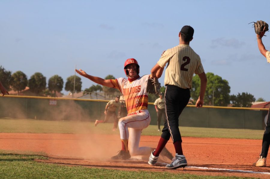 Luke Valenchis pumps up the crowd after reaching third safely during the District Championship on April 29th, 2021.
