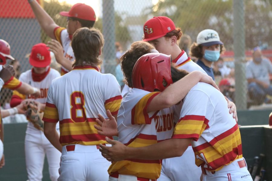 Lucas Scimeca and Jacob LaRoque (helmet) embrace after LaRoque scored in the first inning of a home game against Chaminade-Madonna on March 22, 2021.