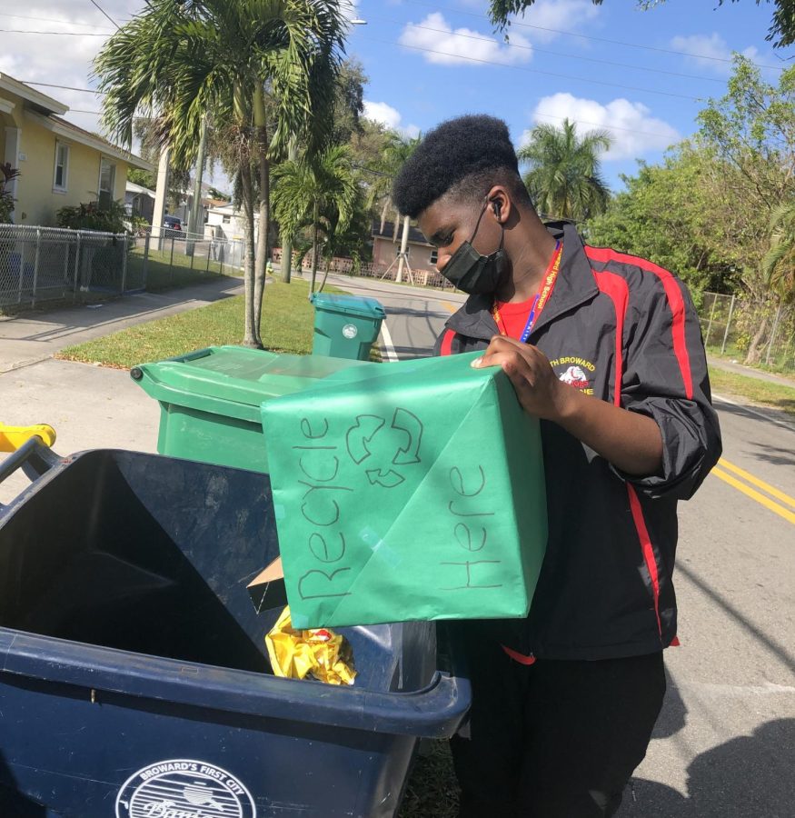 SBHS sophomore, Sean Alcide, participate in recycling week to gain service hours.