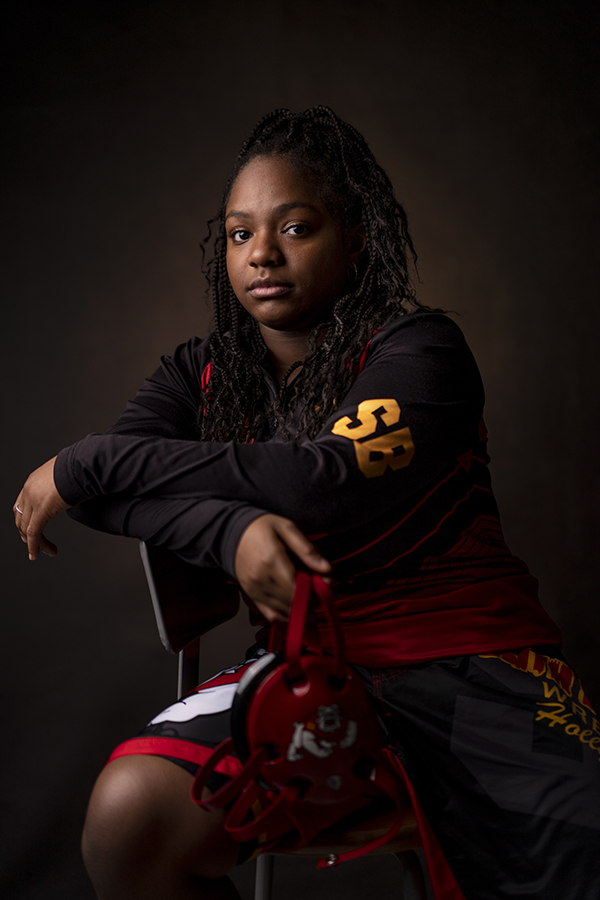 SBHS wrestler Veronica Dorsin sits down as she displays her wrestling attire and gear that she uses in her matches.