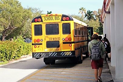 Late bus leaves 20 students wait on a hot sunny day.