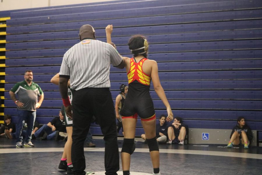 SBHS wrestler Nicole Arroyo wins match by pin against a 110 pound wrestler.
