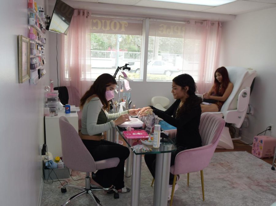 Surrounded by creature comforts, nail tech Shelly Estrada works at her nail station in her newly opened Purple Touch Beauty Salon on Harrison Street in  Hollywood.