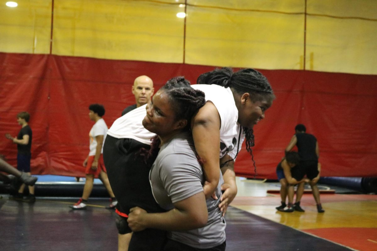 SBHS Sophomore Latoya, executes a perfect fireman carry as Coach Major watches keenly.