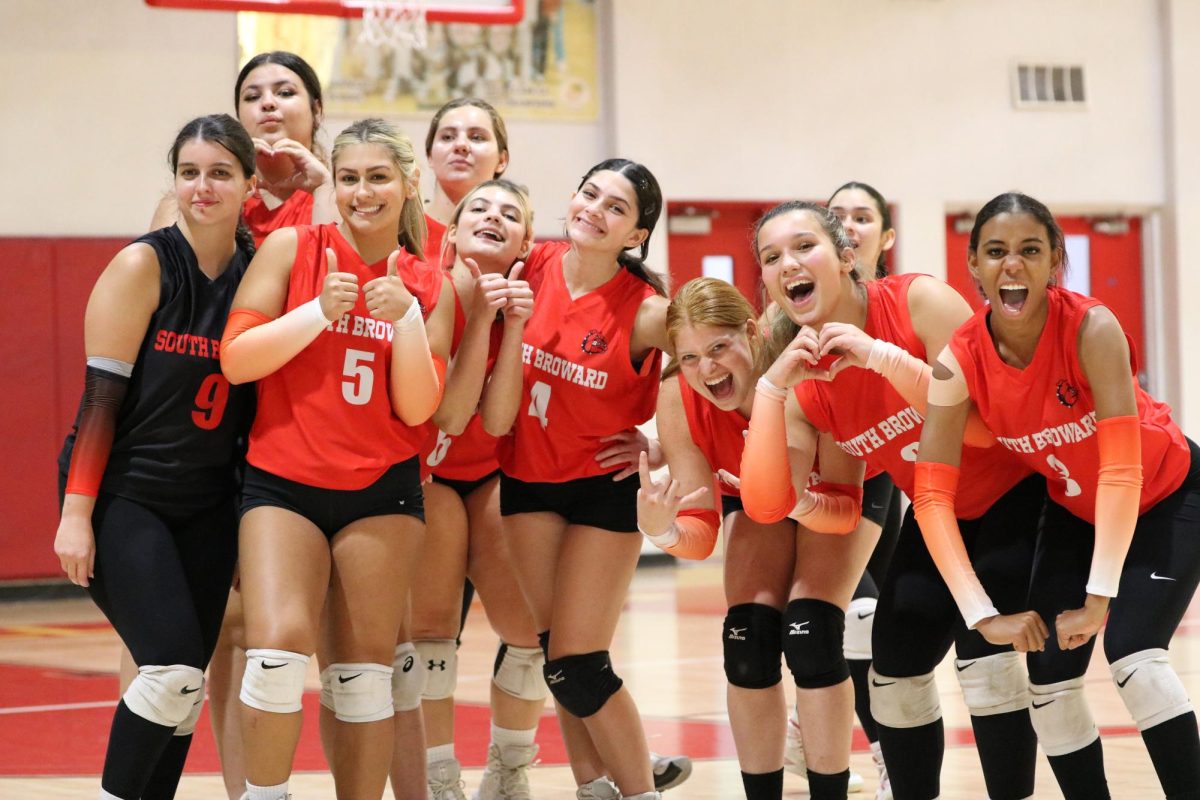 The SBHS Lady Bulldogs pose for a team photo before defeating the McArthur Mustangs in three straight sets.