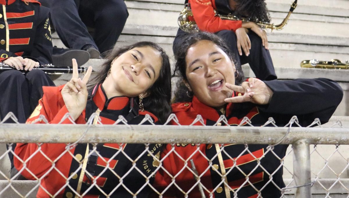 Best friends Alana Valensin and Allyson Barillas pose together after finishing their senior night performance at the last regular season game for football.