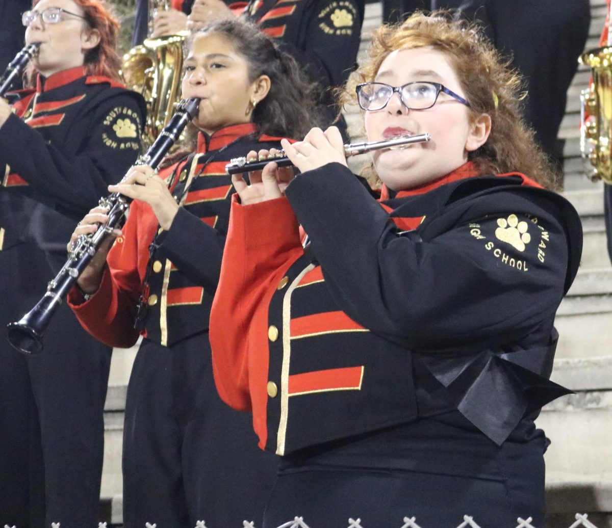 Band secretary Oil Heby and the assistant drum major play their hearts out after SBHSs Varsity football team scores a touchdown.
