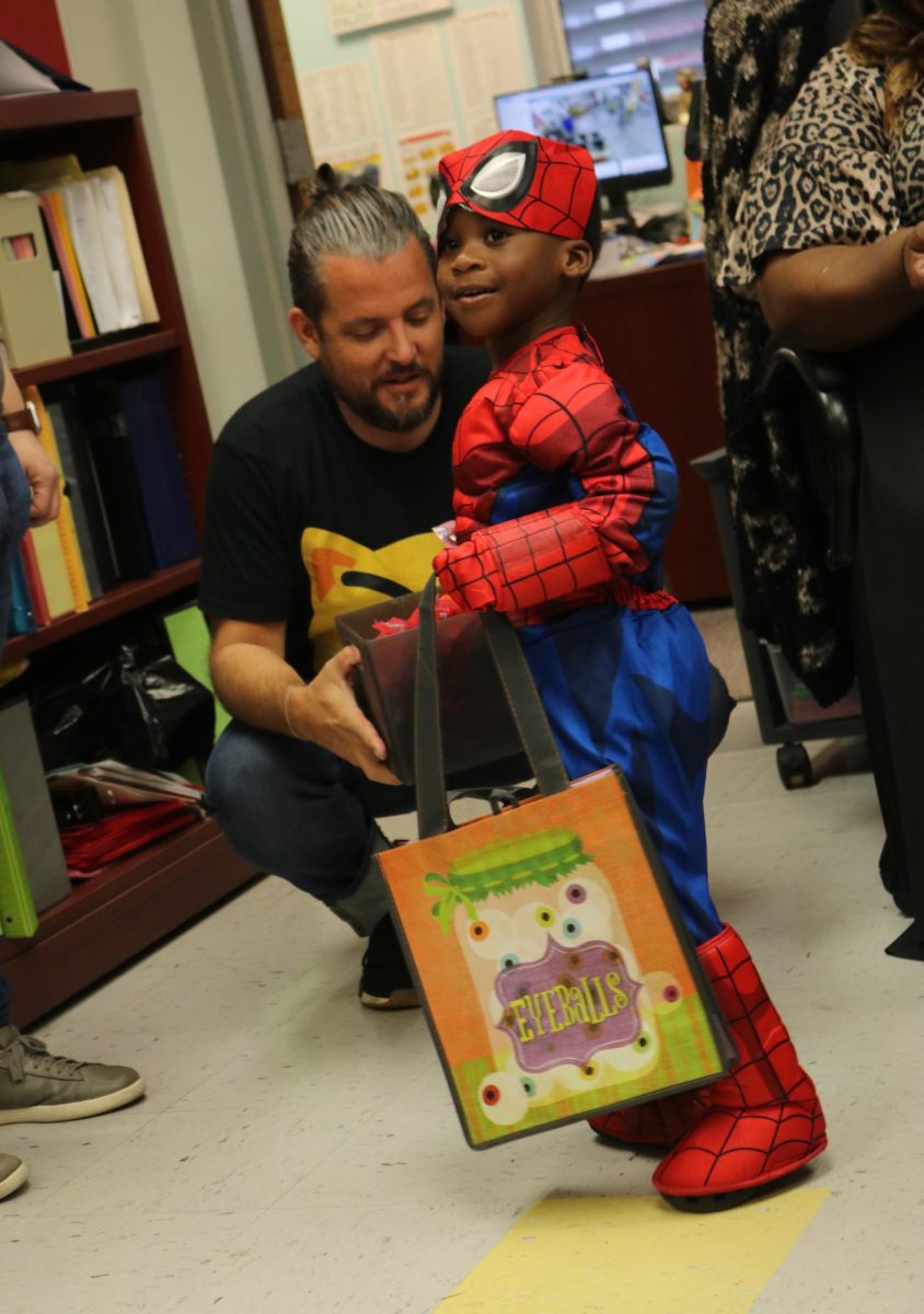 Young Spiderman is super excided to receive his candy but before doing so he looks to his peers to make sure it is okay, after doing so he takes the candy, says thank you to the SBHS staff, and goes on with the rest of his Trick or Treating web adventure.