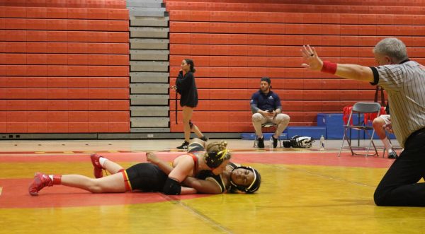 Sophomore Athena Hawn pinning her opponent from Western High going for the win.