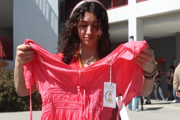 SBHS sophomore, Naielys Rodriguez, looks through the endless piles of clothes coming across a pink summer dress.