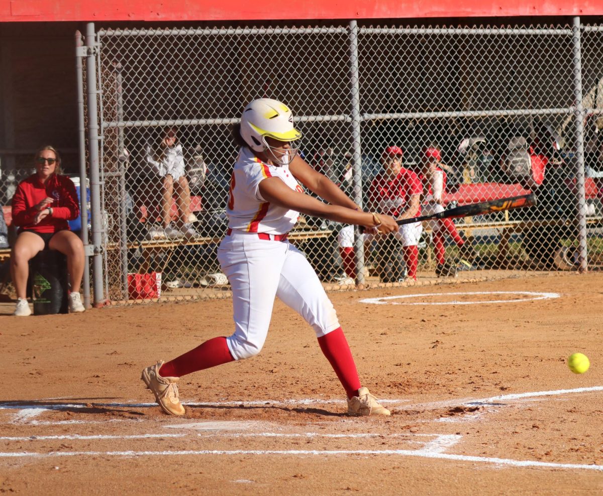 Junior Onya Lee-Golightly swings with determination, connecting solidly with the ball. Lee-Golightly would secure her position at first base, but her journey would end there after the rest of her team struck out.